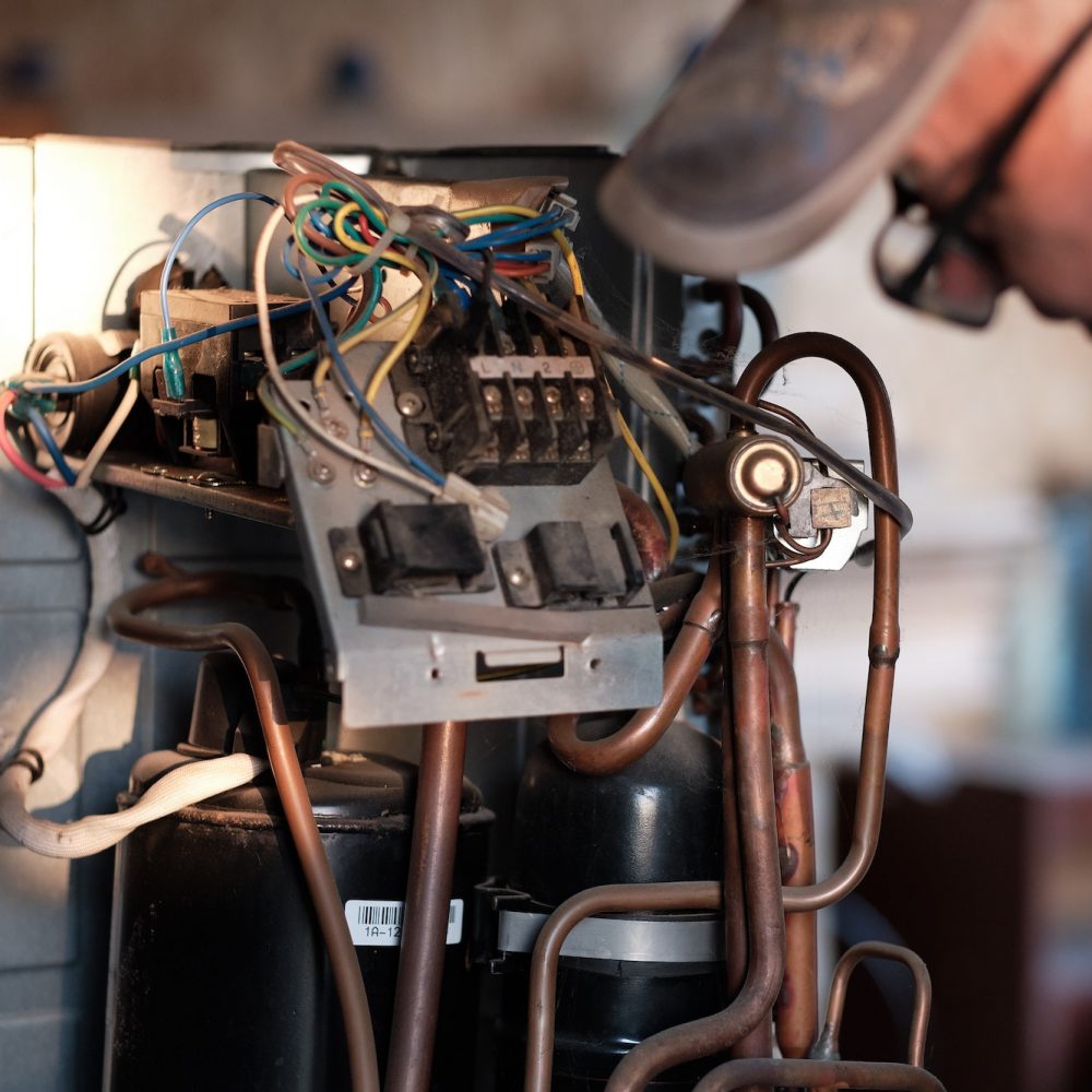 Air conditioner repair. Air conditioner spare parts. mechanic repairs parts. Iron parts.